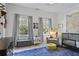 Bright Bedroom featuring a rocking chair, crib, and soft blue rug at 1297 Conway Rd, Decatur, GA 30030