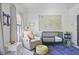 Cozy Bedroom features gray tones, soft lighting, and a comfortable glider at 1297 Conway Rd, Decatur, GA 30030