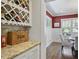 Dining room with granite counter and wine rack with view into dining area at 1297 Conway Rd, Decatur, GA 30030