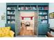 Open view through doorway between bookshelves into dining room with table set for meal at 1297 Conway Rd, Decatur, GA 30030