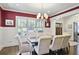Elegant dining room with wainscoting, stylish chandelier, and ample natural light at 1297 Conway Rd, Decatur, GA 30030