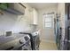 Efficient laundry room with modern washer and dryer, and organized storage racks at 1297 Conway Rd, Decatur, GA 30030