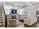 Spacious living room featuring a stone fireplace, built-in bookshelves, and a coffered ceiling with modern fan at 1297 Conway Rd, Decatur, GA 30030