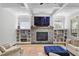 Living room with fireplace, custom built-ins, coffered ceiling, and abundant natural light at 1297 Conway Rd, Decatur, GA 30030