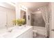 A well-lit bathroom with double sinks and a shower-tub combo provides modern convenience at 3564 Shore Wood Ave, Lawrenceville, GA 30044