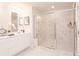 A modern bathroom showcases a glass shower, double vanity with bright lighting and stylish mirrors at 3564 Shore Wood Ave, Lawrenceville, GA 30044