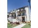 Charming white brick townhome featuring multiple levels, inviting staircases, and manicured landscaping at 3564 Shore Wood Ave, Lawrenceville, GA 30044