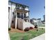 Inviting brick townhome with covered porch, professional landscaping, and for sale sign on a sunny day at 3564 Shore Wood Ave, Lawrenceville, GA 30044