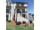 Attractive townhome with white brick, covered porch, and inviting staircase in a landscaped setting at 3564 Shore Wood Ave, Lawrenceville, GA 30044