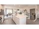 An open concept kitchen with white cabinetry, an island, and stainless steel appliances creates a welcoming space at 3564 Shore Wood Ave, Lawrenceville, GA 30044