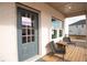Cozy porch with seating, wood flooring, and view of neighboring house with window on a sunny day at 3564 Shore Wood Ave, Lawrenceville, GA 30044