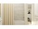 Clean bathroom featuring a tub with shower, tiled walls, and modern fixtures at 416 Valley View Trl, Canton, GA 30115