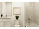 Bright bathroom featuring white cabinets, modern sink, toilet, and stylishly tiled tub at 416 Valley View Trl, Canton, GA 30115