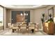 Elegant dining room with a modern chandelier, statement plants, and neutral decor at 416 Valley View Trl, Canton, GA 30115