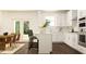Bright kitchen with white cabinetry, stainless appliances, subway tile backsplash, and eat-in dining area at 416 Valley View Trl, Canton, GA 30115