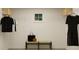 Organized walk-in closet with shelving, hanging racks, and a bench for seating and storage at 416 Valley View Trl, Canton, GA 30115