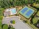 Aerial view showcasing the community pool, tennis courts, and playground areas at 4295 Cami Way, Buford, GA 30519