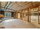Unfinished basement showing exposed insulation, wood framing, and large windows at 4295 Cami Way, Buford, GA 30519