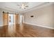 Spacious bedroom showcasing hardwood floors and rustic sliding barn doors to the bathroom at 4295 Cami Way, Buford, GA 30519
