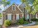 Stunning brick home featuring well-kept landscaping, a light blue door, and mature trees at 4295 Cami Way, Buford, GA 30519