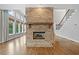 Beautiful living room featuring a brick fireplace, hardwood floors, large windows, and an open floor plan at 4295 Cami Way, Buford, GA 30519