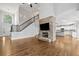 Spacious living room with a fireplace, high ceilings, hardwood floors, and open concept design at 4295 Cami Way, Buford, GA 30519