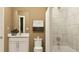 Neutral-toned bathroom with tub and shower combination, marble wall, and bright vanity at 243 Deer Valley Run, Canton, GA 30115