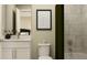 Bathroom with a marble wall shower, a framed black and white print, and an ample vanity at 243 Deer Valley Run, Canton, GA 30115