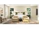 Serene bedroom with neutral tones, two windows and comfortable seating, creating a relaxing retreat at 243 Deer Valley Run, Canton, GA 30115