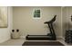 Exercise room with a treadmill, weight rack, and a window for natural light at 243 Deer Valley Run, Canton, GA 30115