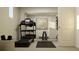 Well-lit exercise room with a treadmill, yoga mat, and a mirrored wall at 243 Deer Valley Run, Canton, GA 30115