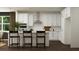 Bright kitchen features white cabinets, stainless steel appliances, and bar seating at the island at 243 Deer Valley Run, Canton, GA 30115