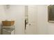 Clean laundry room featuring a storage basket and a glimpse into another room at 243 Deer Valley Run, Canton, GA 30115