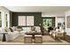 Open-concept living room with stylish furnishings and dining area, flowing natural light at 243 Deer Valley Run, Canton, GA 30115