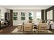 Spacious living room with hardwood floors, comfortable seating, and large windows at 243 Deer Valley Run, Canton, GA 30115