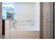 Bathroom featuring a tub with marble tile and granite countertop at 390 17Th Nw St # 2040, Atlanta, GA 30363