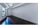 Bright bedroom with dark hardwood floors and a large window providing natural light at 390 17Th Nw St # 2040, Atlanta, GA 30363