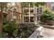 Serene condo courtyard with lush landscaping, mature trees, and direct access to multiple units at 390 17Th Nw St # 2040, Atlanta, GA 30363