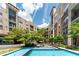Exterior view of courtyard featuring a fountain, patio seating, and manicured green space at 390 17Th Nw St # 2040, Atlanta, GA 30363