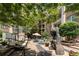 Well-maintained community courtyard with lounge seating, artistic sculpture, and lush landscape at 390 17Th Nw St # 2040, Atlanta, GA 30363