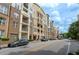 Street view of a multi-story apartment building with a mix of brick and siding, plus street parking at 390 17Th Nw St # 2040, Atlanta, GA 30363
