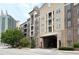 Multi-story building featuring an entry drive-through, neutral tones, and a mix of brick and siding at 390 17Th Nw St # 2040, Atlanta, GA 30363