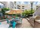 Community grilling and patio area with stainless steel grill, dining tables, and manicured landscaping at 390 17Th Nw St # 2040, Atlanta, GA 30363