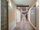 Neutral hallway featuring warm beige walls, tile flooring, modern wall sconces, and decorative glass block accents at 390 17Th Nw St # 2040, Atlanta, GA 30363