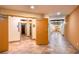 Warm lobby area with tile flooring, elevator access, and wood-framed doorway leading to well-lit hallway at 390 17Th Nw St # 2040, Atlanta, GA 30363
