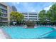 A large pool with lounge chairs and lush trees, creating a serene oasis for residents at 390 17Th Nw St # 2040, Atlanta, GA 30363