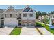 Charming two-story home with a modern exterior design, a well-manicured lawn, and a spacious driveway at 415 Camrose Ave, Union City, GA 30291