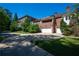 Exterior view of the estate with manicured lawn, a circular driveway, and lush greenery around the garages at 4790 Shallowford Rd, Roswell, GA 30075