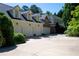 Attached garages offering ample parking and storage, complemented by lush greenery surrounding the property at 4790 Shallowford Rd, Roswell, GA 30075