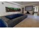Bright room featuring an indoor tiled swimming pool, large screen television and access to an exterior living space at 4790 Shallowford Rd, Roswell, GA 30075